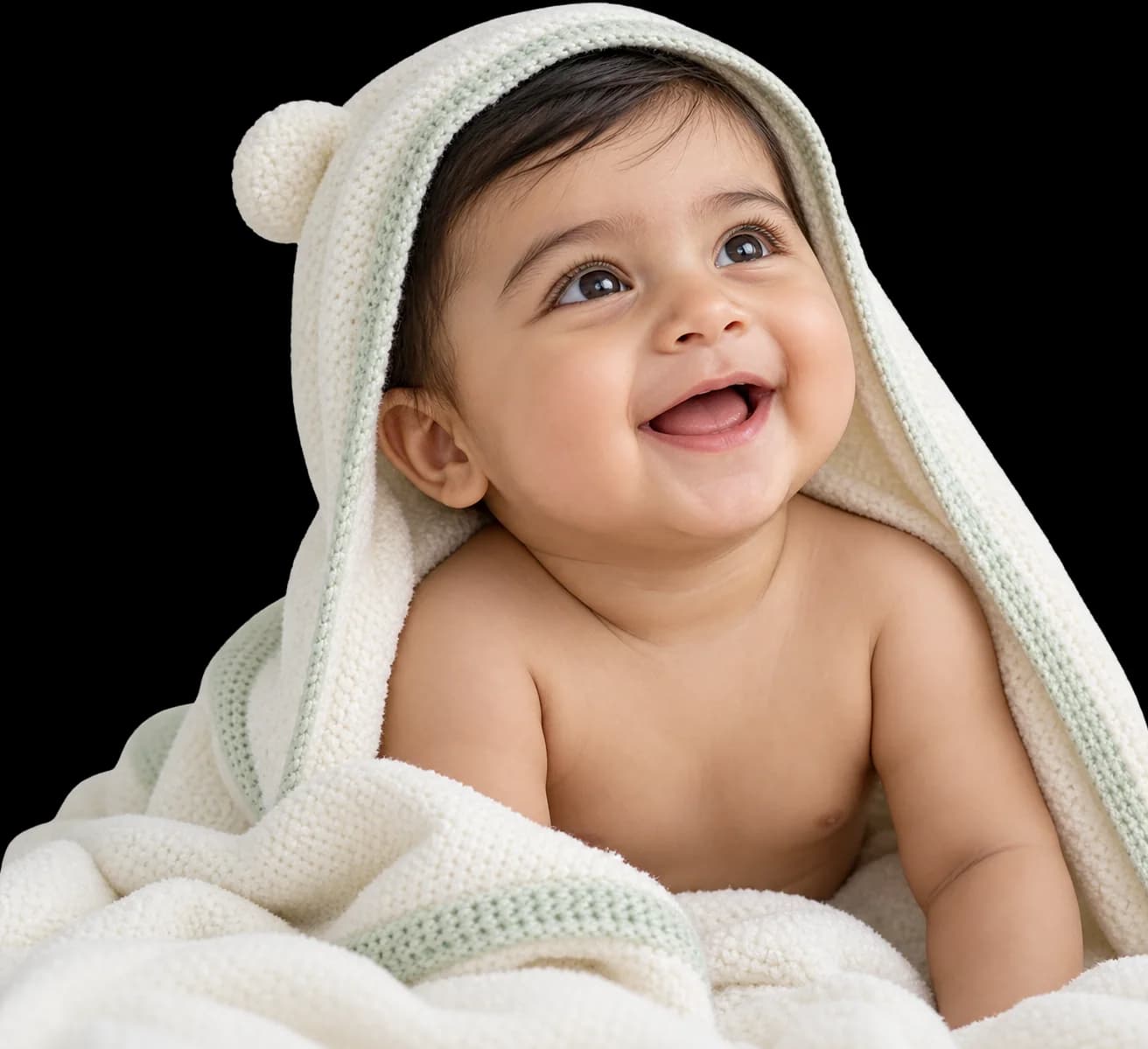 Happy baby wrapped in a soft cream towel